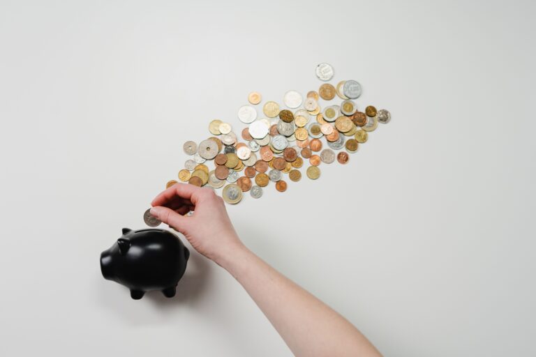 Hombre joven revisando ahorros y documentos financieros en laptop